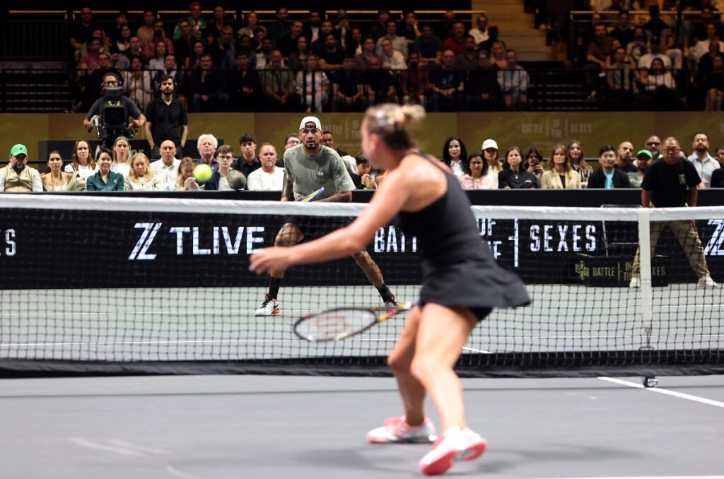 Nick Kyrgios eyes the ball in front of Aryna Sabalenka during their Battle of the Sexes match, in Dubai, United Arab Emirates, Sunday Dec. 28, 2025. (Christopher Pike/Pool Photo via AP)