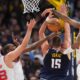 Denver Nuggets center Nikola Jokić, third from left, has his shot blocked by, from left, Houston Rockets center Alperen Sengun and forwards Kevin Durant and Jabari Smith Jr. in overtime of an NBA basketball game Monday, Dec. 15, 2025, in Denver. (AP Photo/David Zalubowski)
