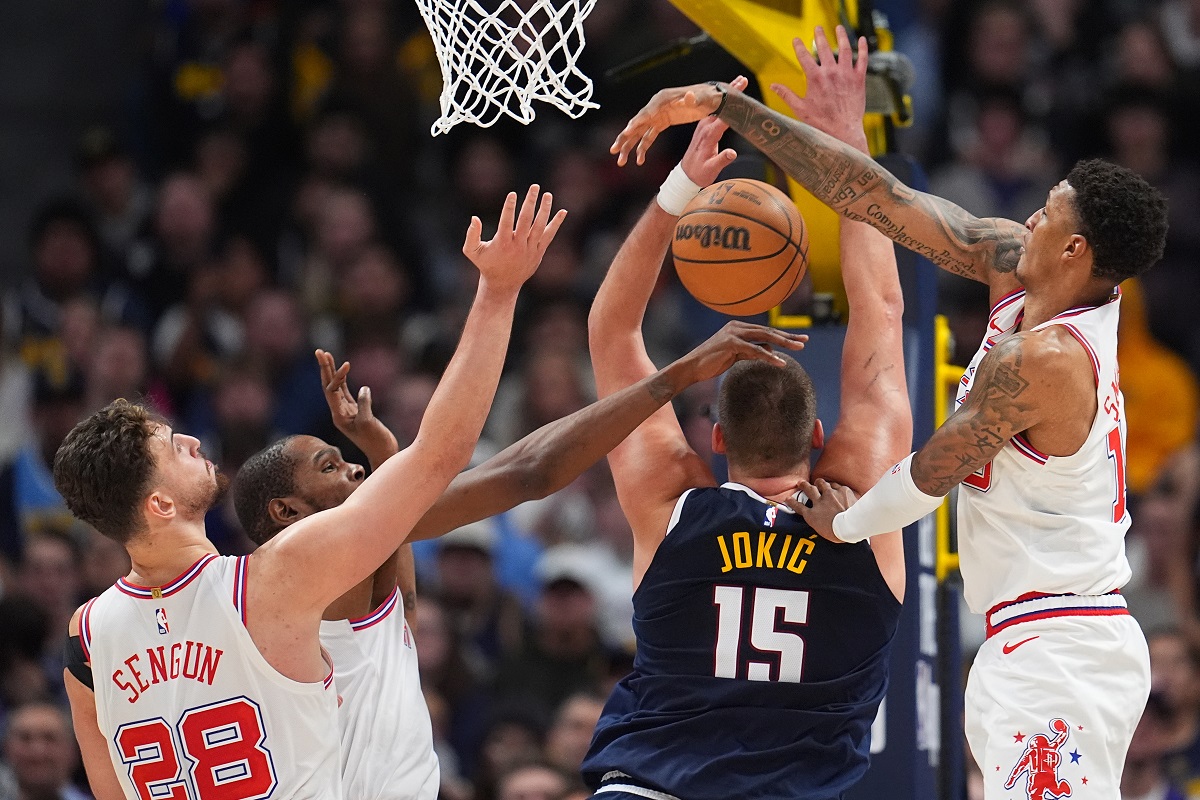 Denver Nuggets center Nikola Jokić, third from left, has his shot blocked by, from left, Houston Rockets center Alperen Sengun and forwards Kevin Durant and Jabari Smith Jr. in overtime of an NBA basketball game Monday, Dec. 15, 2025, in Denver. (AP Photo/David Zalubowski)