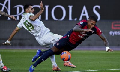 Cagliari's Michael Folorunsho, right, falls after an action with Roma's Mehmet Zeki Çelik, during a Serie A soccer match between Cagliari and Roma, in Cagliari, Italy, Sunday, Dec. 7, 2025. (Gianluca Zuddas/LaPresse via AP)