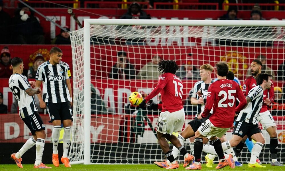Manchester United's Patrick Dorgu, center left, scores the opening goal during the English Premier League soccer match between Manchester United and Newcastle in Manchester, England, Friday, Dec. 26, 2025. (AP Photo/Dave Thompson)