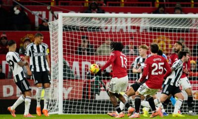 Manchester United's Patrick Dorgu, center left, scores the opening goal during the English Premier League soccer match between Manchester United and Newcastle in Manchester, England, Friday, Dec. 26, 2025. (AP Photo/Dave Thompson)