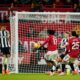 Manchester United's Patrick Dorgu, center left, scores the opening goal during the English Premier League soccer match between Manchester United and Newcastle in Manchester, England, Friday, Dec. 26, 2025. (AP Photo/Dave Thompson)