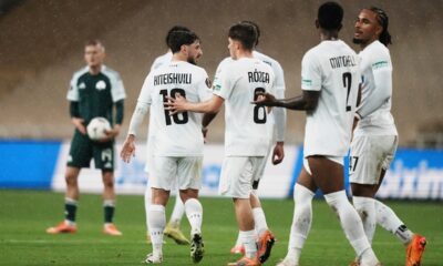 Sturm's Otar Kiteishvili , left, is congratulated by teammates after scoring his side's first goal during the Europa League opening phase soccer match between Panathinaikos and Sturm Graz in Athens, Greece, Thursday, Nov. 27, 2025. (AP Photo/Thanassis Stavrakis)