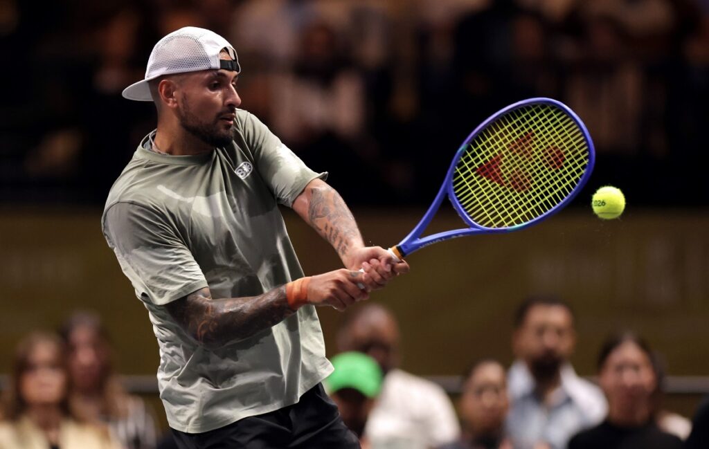 Nick Kyrgios plays a backhand against Aryna Sabalenka during their Battle of the Sexes match in Dubai, United Arab Emirates, Sunday Dec. 28, 2025. (Christopher Pike/Pool Photo via AP)
