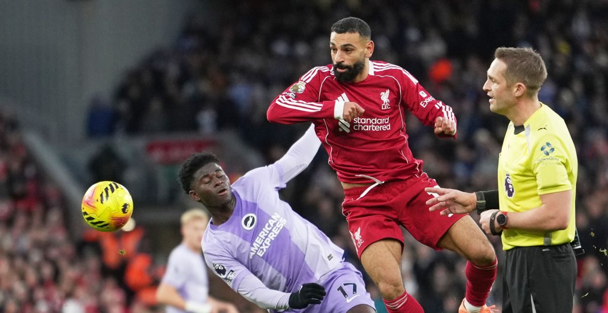 Liverpool's Mohamed Salah, centre, challenges for the ball with Brighton's Carlos Baleba, left, during the English Premier League soccer match between Liverpool and Brighton and Hove Albion in Liverpool, England, Saturday, Dec. 13, 2025. (AP Photo/Jon Super)
