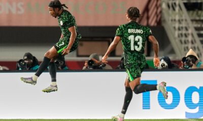 Nigeria's Ademola Lookman, left, celebrates after scoring his side's third goal during the Africa Cup of Nations group C soccer match between Nigeria and Tunisia in Fez, Morocco, Saturday, Dec. 27, 2025. (AP Photo/Mosa'ab Elshamy)