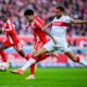 Munich's Luis Diaz, left, and Stuttgart's Josha Vagnoman, right, challenge for the ball during the German Bundesliga soccer match between VfB Stuttgart and FC Bayern Munich in Stuttgart, Germany, Saturday, Dec. 6, 2025. (Tom Weller/dpa via AP)