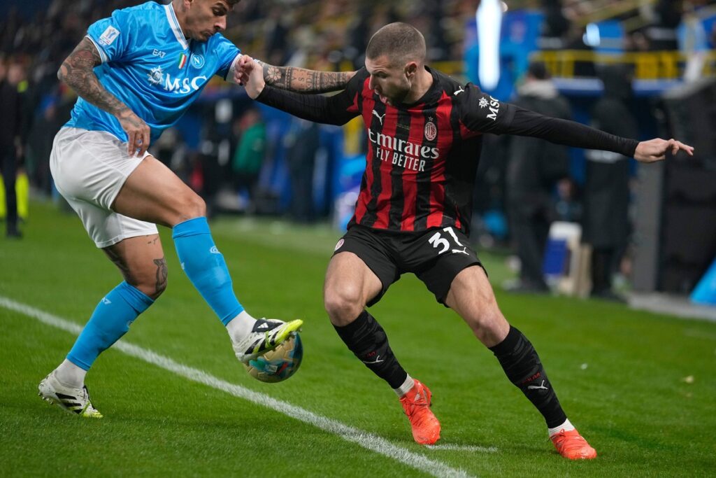 AC Milan's Strahinja Pavlovic challenges for the ball with Napoli's Giovanni Di Lorenzo during an Italian Super Cup soccer match between Napoli and AC Milan in Riyadh, Saudi Arabia, Thursday, Dec. 18, 2025. (AP Photo/Altaf Qadri)
