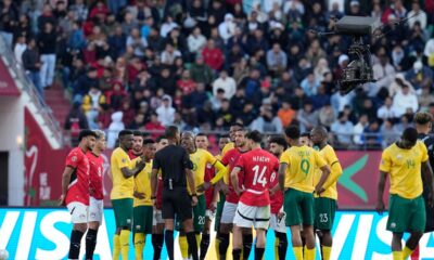 Players gather around the referee Pacifique Ndabihawenimana while a penalty kick check is being conducted during the Africa Cup of Nations group B soccer match between Egypt and South Africa in Agadir, Morocco, Friday, Dec. 26, 2025. (AP Photo/Themba Hadebe)