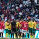 Players gather around the referee Pacifique Ndabihawenimana while a penalty kick check is being conducted during the Africa Cup of Nations group B soccer match between Egypt and South Africa in Agadir, Morocco, Friday, Dec. 26, 2025. (AP Photo/Themba Hadebe)