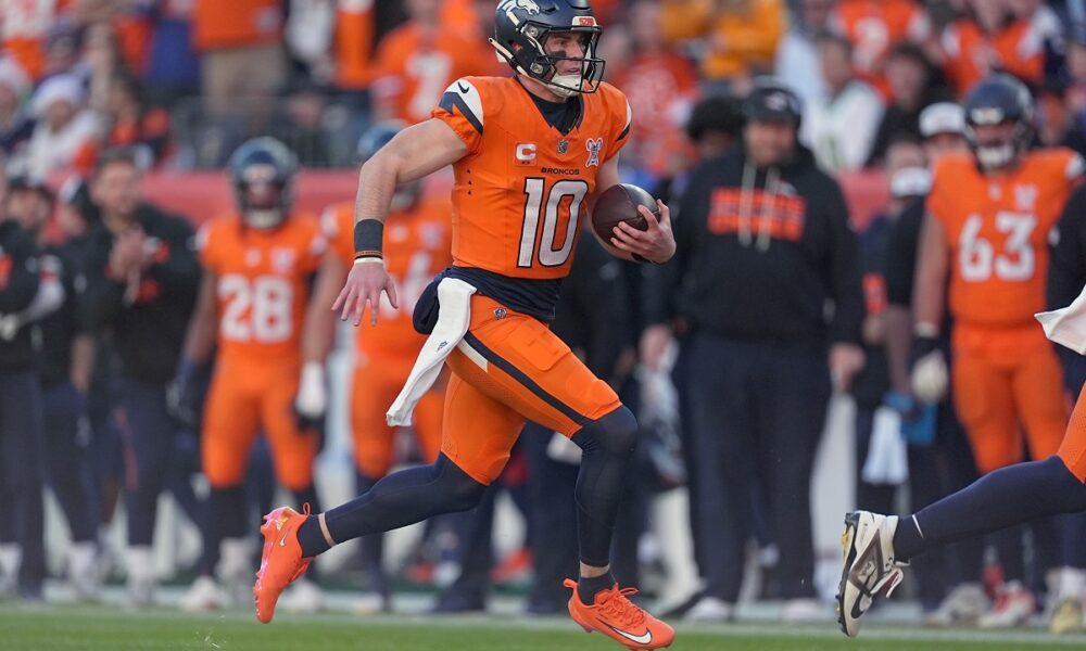Denver Broncos quarterback Bo Nix (10) runs against the Jacksonville Jaguars during the first half of an NFL football game in Denver, Sunday, Dec. 21, 2025. (AP Photo/David Zalubowski)