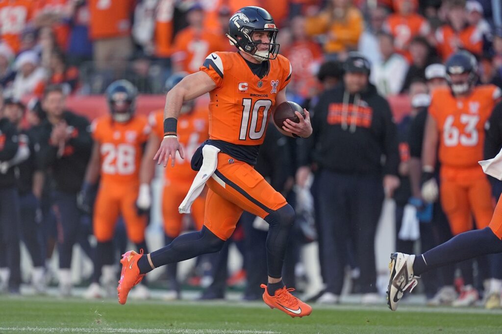Denver Broncos quarterback Bo Nix (10) runs against the Jacksonville Jaguars during the first half of an NFL football game in Denver, Sunday, Dec. 21, 2025. (AP Photo/David Zalubowski)
