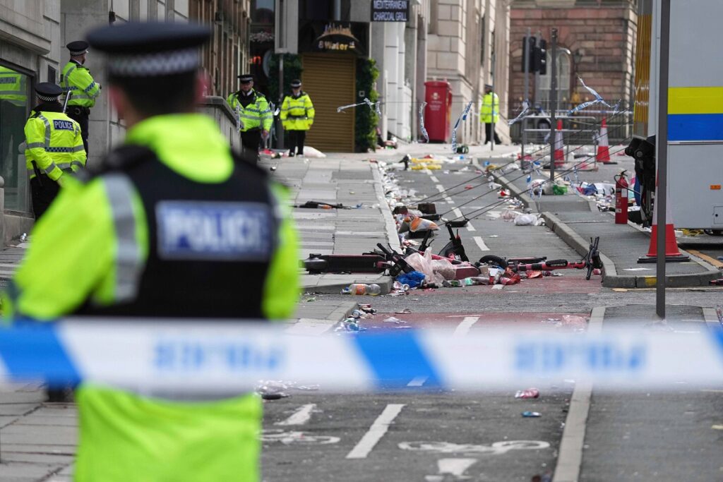 FILE - Police guards the site where a 53-year-old British man plowed a minivan into a crowd of Liverpool soccer fans who were celebrating the city's Premier League championship Monday, injuring more than 45 people in Liverpool, England, Tuesday, May 27, 2025.(AP Photo/Jon Super, File)