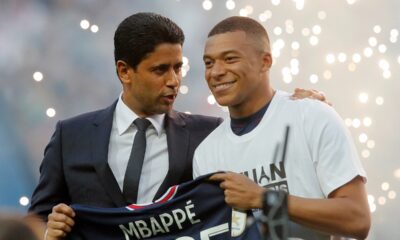 FILE - PSG President Nasser Al-Khelaifi, left, speaks to PSG's Kylian Mbappe as it is announced he has signed a three year extension to his contract, at the Parc des Princes stadium in Paris, France, Saturday, May 21, 2022. (AP Photo/Michel Spingler, File)