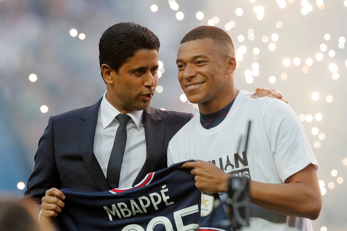 FILE - PSG President Nasser Al-Khelaifi, left, speaks to PSG's Kylian Mbappe as it is announced he has signed a three year extension to his contract, at the Parc des Princes stadium in Paris, France, Saturday, May 21, 2022. (AP Photo/Michel Spingler, File)