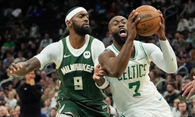 Boston Celtics' Jaylen Brown (7) drives to the basket against Milwaukee Bucks' Bobby Portis (9) during the second half of an NBA basketball game Thursday, Dec. 11, 2025, in Milwaukee. (AP Photo/Aaron Gash)