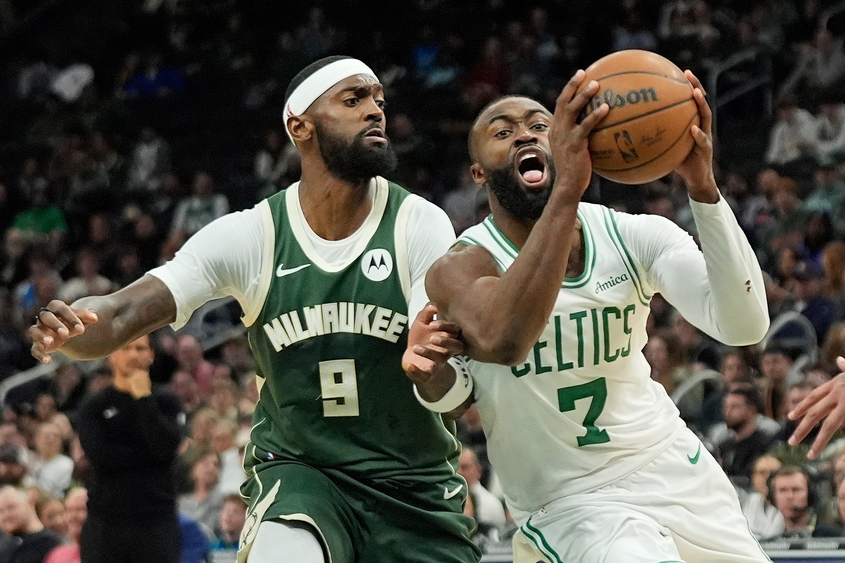 Boston Celtics' Jaylen Brown (7) drives to the basket against Milwaukee Bucks' Bobby Portis (9) during the second half of an NBA basketball game Thursday, Dec. 11, 2025, in Milwaukee. (AP Photo/Aaron Gash)