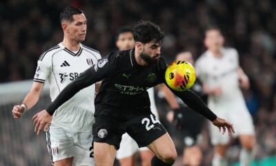 Fulham's Sasa Lukic, left, vies for the ball against Manchester City's Josko Gvardiol during the English Premier League soccer match between Fulham and Manchester City in London, Tuesday, Dec. 2, 2025. (AP Photo/Kirsty Wigglesworth)