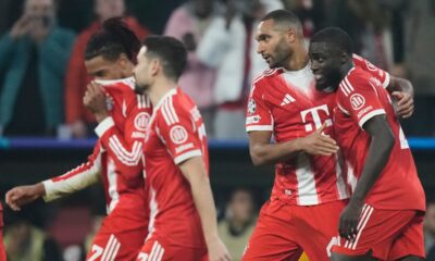 Bayern Munich players celebrate after Bayern's Jonathan Tah, second right, scored his side's third goal during the Champions League opening phase soccer match between FC Bayern Munich and Sporting CP in Munich, Germany, Tuesday, Dec. 9, 2025. (AP Photo/Matthias Schrader)