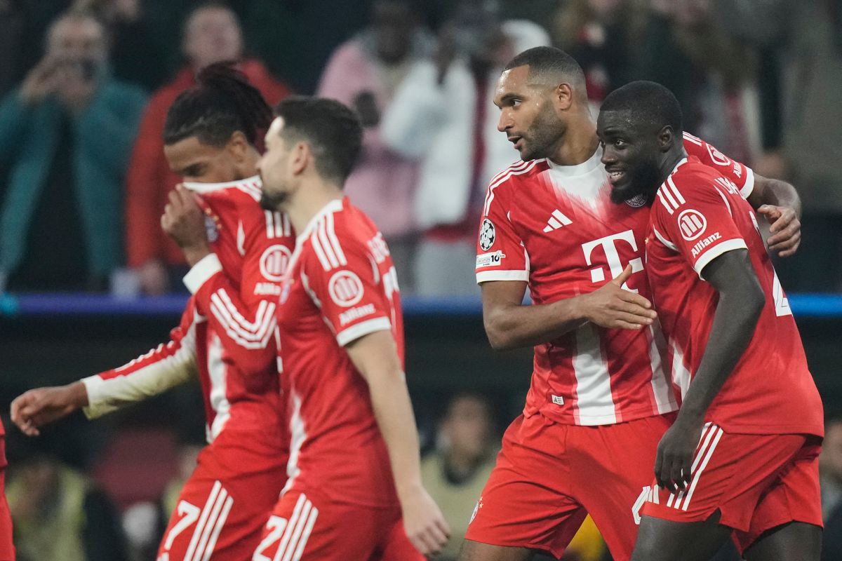 Bayern Munich players celebrate after Bayern's Jonathan Tah, second right, scored his side's third goal during the Champions League opening phase soccer match between FC Bayern Munich and Sporting CP in Munich, Germany, Tuesday, Dec. 9, 2025. (AP Photo/Matthias Schrader)