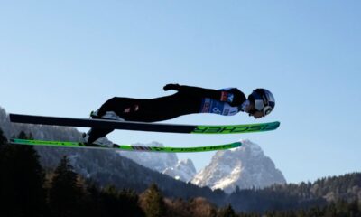 Stephan Embacher, of Austria, soars through the air, with the Zugspitze and Waxenstein mountains in the background, during his trial jump at the second stage of the Four Hills ski jumping tournament in Garmisch-Partenkirchen, Germany, Wednesday, Dec. 31, 2025. (AP Photo/Matthias Schrader)