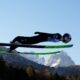 Stephan Embacher, of Austria, soars through the air, with the Zugspitze and Waxenstein mountains in the background, during his trial jump at the second stage of the Four Hills ski jumping tournament in Garmisch-Partenkirchen, Germany, Wednesday, Dec. 31, 2025. (AP Photo/Matthias Schrader)
