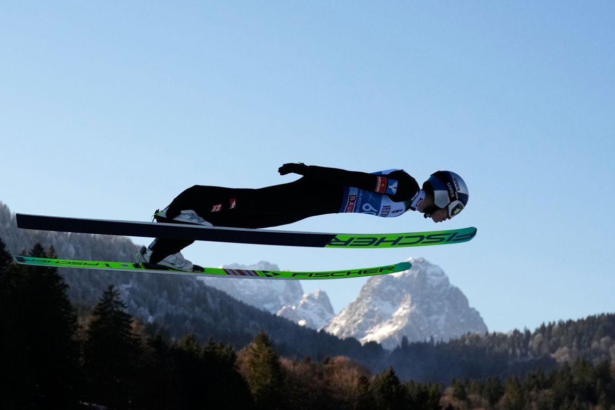 Stephan Embacher, of Austria, soars through the air, with the Zugspitze and Waxenstein mountains in the background, during his trial jump at the second stage of the Four Hills ski jumping tournament in Garmisch-Partenkirchen, Germany, Wednesday, Dec. 31, 2025. (AP Photo/Matthias Schrader)