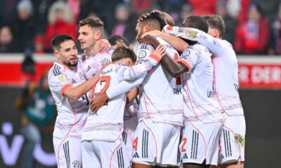 Bayern's Josip Stanisic celebrates with teammates after scoring their side's first goal of the game during the Bundesliga soccer match between FC Heidenheim and Bayern Munich, in Heidenheim, Germany, Sunday Dec. 21, 2025. (Harry Langer/dpa via AP)