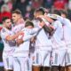 Bayern's Josip Stanisic celebrates with teammates after scoring their side's first goal of the game during the Bundesliga soccer match between FC Heidenheim and Bayern Munich, in Heidenheim, Germany, Sunday Dec. 21, 2025. (Harry Langer/dpa via AP)