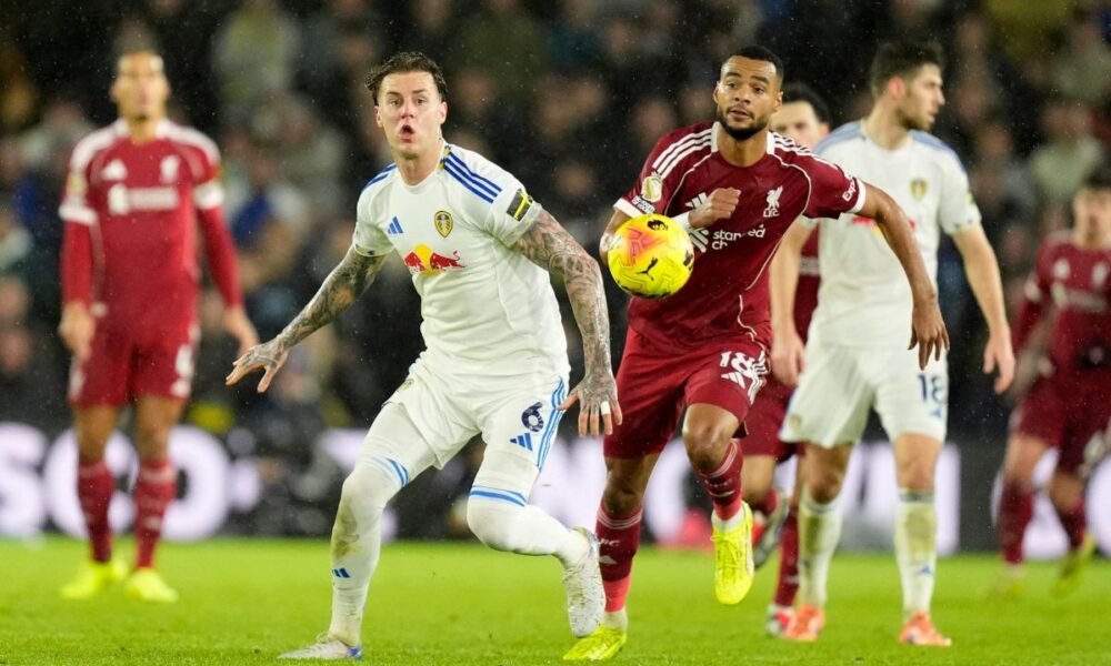 Liverpool's Cody Gakpo, right, and Leeds United's Joe Rodon in action during the English Premier League soccer match between Leeds United and Liverpool in Leeds, England, Saturday Dec. 6, 2025. (Danny Lawson/PA via AP)