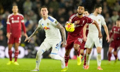 Liverpool's Cody Gakpo, right, and Leeds United's Joe Rodon in action during the English Premier League soccer match between Leeds United and Liverpool in Leeds, England, Saturday Dec. 6, 2025. (Danny Lawson/PA via AP)