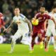 Liverpool's Cody Gakpo, right, and Leeds United's Joe Rodon in action during the English Premier League soccer match between Leeds United and Liverpool in Leeds, England, Saturday Dec. 6, 2025. (Danny Lawson/PA via AP)