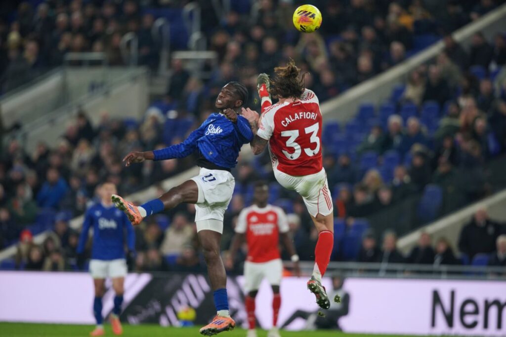 Everton's Thierno Barry, left, and Arsenal's Riccardo Calafiori vie for the ball during the English Premier League soccer match between Everton and Arsenal in Liverpool, England, Saturday, Dec. 20, 2025. (AP Photo/Ian Hodgson)
