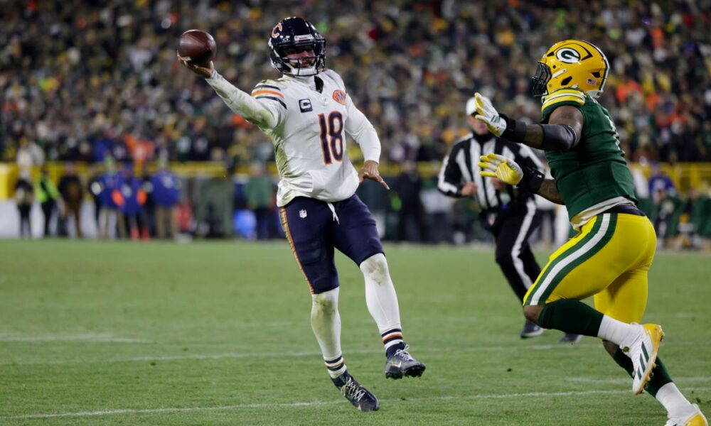 Chicago Bears quarterback Caleb Williams (18) throws a pass for a touchdown against Green Bay Packers defensive end Micah Parsons, right, during the second half of an NFL football game Sunday, Dec. 7, 2025, in Green Bay, Wis. (AP Photo/Matt Ludtke)
