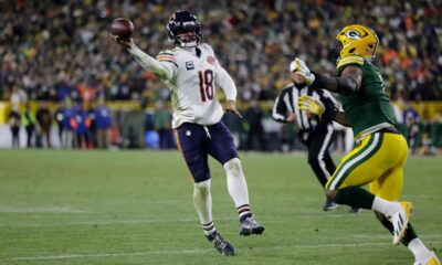 Chicago Bears quarterback Caleb Williams (18) throws a pass for a touchdown against Green Bay Packers defensive end Micah Parsons, right, during the second half of an NFL football game Sunday, Dec. 7, 2025, in Green Bay, Wis. (AP Photo/Matt Ludtke)