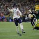 Chicago Bears quarterback Caleb Williams (18) throws a pass for a touchdown against Green Bay Packers defensive end Micah Parsons, right, during the second half of an NFL football game Sunday, Dec. 7, 2025, in Green Bay, Wis. (AP Photo/Matt Ludtke)
