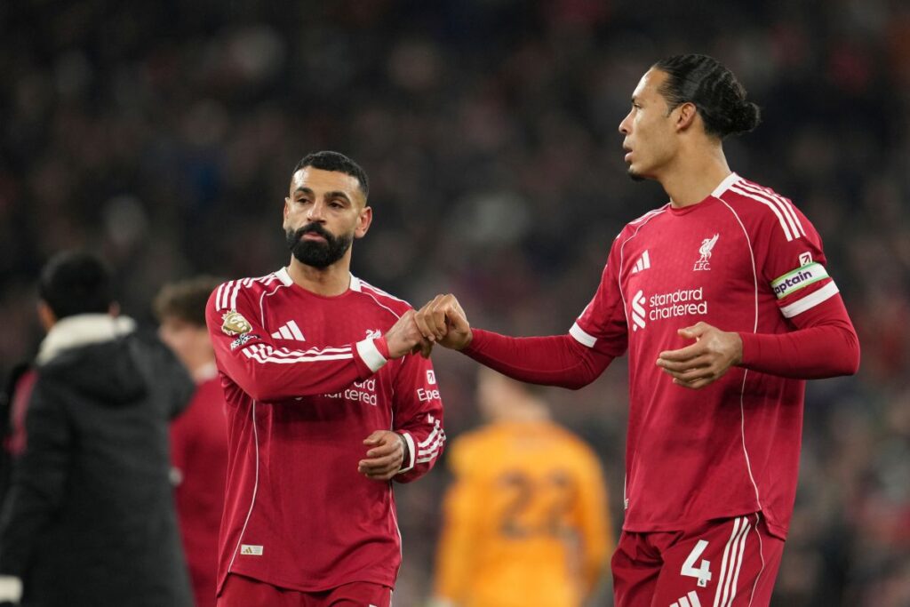 Liverpool's Mohamed Salah, left, and Virgil van Dijk greet each other after the English Premier League soccer match between Liverpool and Sunderland in Liverpool, Wednesday, Dec. 3, 2025. (AP Photo/Jon Super)