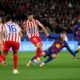 Atletico Madrid's Clement Lenglet fights for the ball against Barcelona's Dani Olmo during a Spanish La Liga soccer match between Barcelona and Atletico de Madrid, in Barcelona, Spain, Tuesday, Dec.2, 2025. (AP Photo/Joan Monfort)