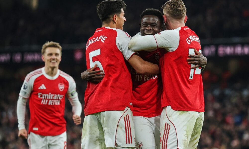 Arsenal's Bukayo Saka, second right, celebrates with teammates after his team scored the opening goal during the English Premier League soccer match between Arsenal and Wolves in London, Sunday, Dec. 14, 2025. (AP Photo/Richard Pelham)