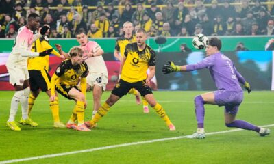 Leverkusen's Ibrahim Maza, center scores the opening goal during the German Soccer Cup round of sixteen soccer match between Borussia Dortmund and Bayer 04 Leverkusen in Dortmund, Germany, Tuesday, Dec. 2, 2025. (AP Photo/Martin Meissner)