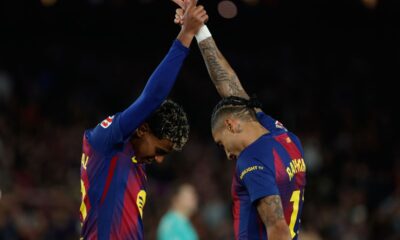 Barcelona's Raphinha and Lamine Yamal celebrate after a goal during a La Liga soccer match between Barcelona and Osasuna in Barcelona, Spain, Saturday, Dec. 13, 2025. AP Photo/Joan Monfort)