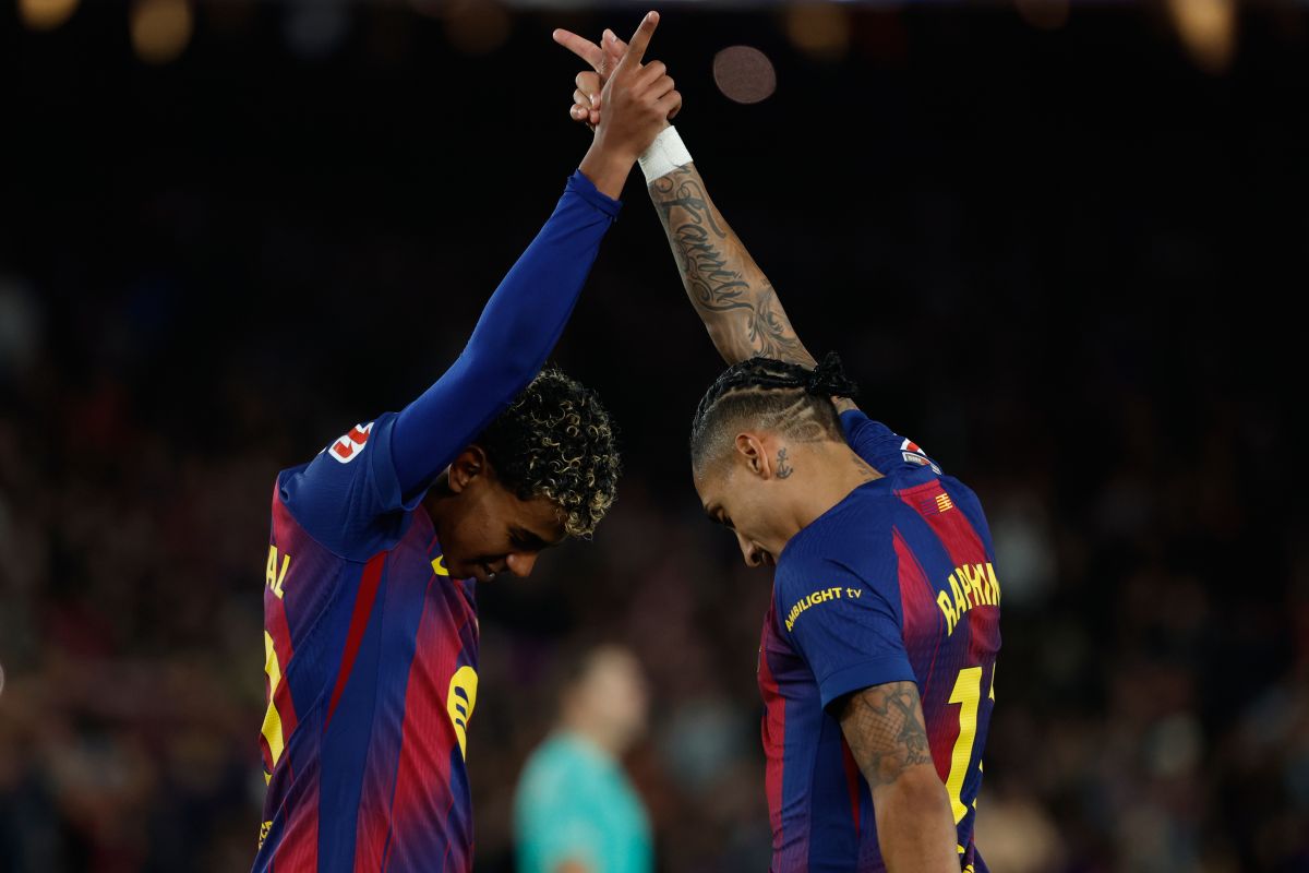 Barcelona's Raphinha and Lamine Yamal celebrate after a goal during a La Liga soccer match between Barcelona and Osasuna in Barcelona, Spain, Saturday, Dec. 13, 2025. AP Photo/Joan Monfort)
