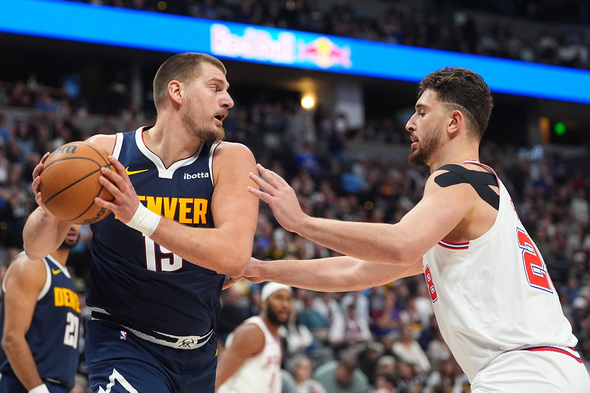 Denver Nuggets center Nikola Jokic pulls in a rebound as Houston Rockets center Alperen Sengun defends in the second half of an NBA basketball game Monday, Dec. 15, 2025, in Denver. (AP Photo/David Zalubowski)