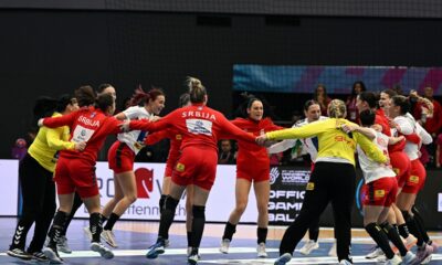 Serbia's players celebrate their win over Spain after the women's handball World Championship match between Spain and Serbia in Dortmund, Germany, Tuesday, Dec. 2, 2025. (Federico Gambarini/dpa via AP)