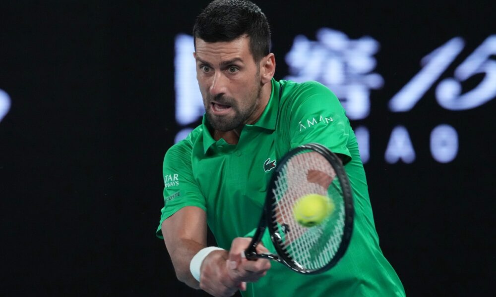 Novak Djokovic of Serbia plays a backhand return to Pedro Martinez of Spain during their first round match at the Australian Open tennis championship in Melbourne, Australia, Monday, Jan. 19, 2026. (AP Photo/Aaron Favila)