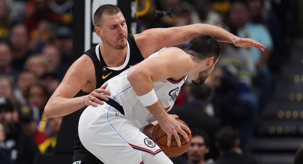 Los Angeles Clippers center Ivica Zubac, front, is covered by Denver Nuggets center Nikola Jokić, back, in the first half of an NBA basketball game Friday, Jan. 30, 2026, in Denver. (AP Photo/David Zalubowski)