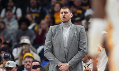 Injured Denver Nuggets center Nikola Jokic looks on from the sideline in the second half of an NBA basketball game against the Atlanta Hawks, Friday, Jan. 9, 2026, in Denver. (AP Photo/David Zalubowski)