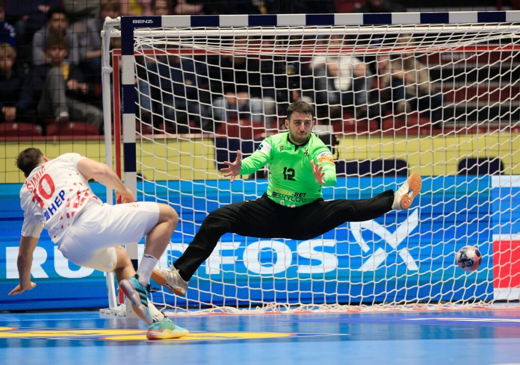 Croatia's Josip Simic scores past Georgia goalkeeper Zurab Tsintsadze during the European Championship handball match between Croatia and Georgia, in Malmo, Sweden, Saturday Jan. 17, 2026. (Andreas Hillergren/Ritzau Scanpix via AP)