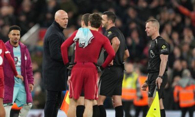Liverpool's manager Arne Slot, left, talks with referee Andy Madley after the English Premier League soccer match between Liverpool and Burnley in Liverpool, England, Saturday, Jan. 17, 2026. (AP Photo/Jon Super)